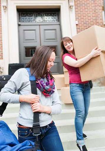 Older teens with luggage and moving boxes
